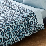 This printed cheetah spot ventures into the wild to turn your personal habitat into an exotic escape. In hues of blue, black and white, its unconventional tonality creates a bold focal point.