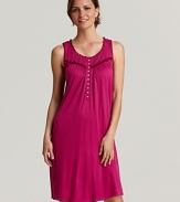 Sweet dreams start wtih this flowy short knit gown with ruffle trim and flower button accents.