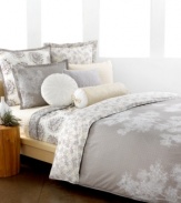 The Snow Willow comforter set captures the beauty of winter in neutral colors fit for all seasons. Scattered white branches grow across a muted, geometric design while the reverse presents a collection of these branches in calming color.