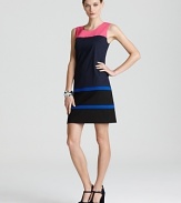 Vibrant stripes interrupt the sleek navy silhouette of this DKNY shift dress for vivid alternative to the classic LBD.