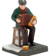 An accordion player makes everything that much merrier, playing for patrons of Murphy's Irish Pub. It's all part of the fun from the Department 56 Christmas in the City collection.