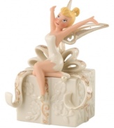 Let your imagination take flight with a hint of pixie dust. Never Land's illustrious fairy, Tinkerbell, strikes a joyful pose atop a beautifully embossed gift. In ivory porcelain with swirls of gold, this Lenox figurine makes Disney magic happen at home. Qualifies for Rebate