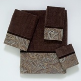 Luxurious velour decorative towel is embellished with a woven classic paisley border design in browns and blues. The border is finished off with a coordinating brown velvet ribbon.