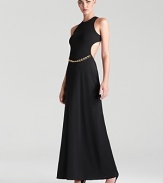 A racerback silhouette lends a dressed up, sporty look to BCBGMAXAZRIA's chain-belted gown.
