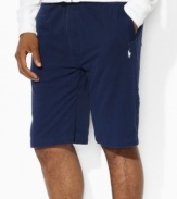 A relaxed-fitting tennis short is crafted from breathable cotton mesh with an elasticized drawstring waist for sleek comfort and casual style.