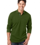 Stock up on casual staples like this subtly textured pique polo shirt from Izod and wear it all season long. (Clearance)