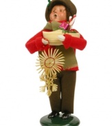 A young boy helps with the holiday shopping, picking up a traditional straw ornament and clog full of goodies in this handcrafted figurine from Byers' Choice.