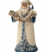 Santa shimmers & shines. Dressing up in brilliant blue & silver hues, Santa takes a moment to decorate your home with a string of festive garland.