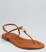 Simply the essence of chic, easy summer style, these slim-strapped flats are equally at home on city streets and sandy beaches. By Tory Burch.