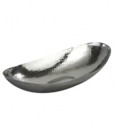 Minimalism at its best. With a hammered interior and simply elegant oval shape, this stainless steel bowl from Leeber's collection of serveware and serving dishes is a beautiful accent on its own and the perfect home for fruit or flowers.