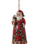 The holiday just got happier. Santa Claus and a four-legged friend join forces in one over-the-top merry Christmas ornament, crafted with the traditional folk-art styling of Jim Shore.