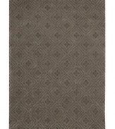 Bold yet subtle, this graceful area rug is punctuated with fine florets within an all-over diamond design. Hand tufted from 100% natural wool, this plush Calvin Klein rug is crafted using the cut-and-loop pile technique that creates a unique matte surface texture.