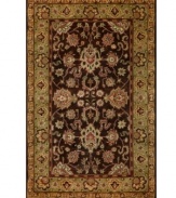 Drawing inspiration from the sandy ruins of ancient Petra and the traditional designs of India, this elegant, hand-tufted rug presents a rich decorative history set against an earthy backdrop and accented with multiple gold and plum tones.
