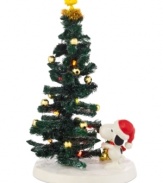 Woodstock is the star of Snoopy's expertly decked tree in this comical collectible from Peanuts Village, by Department 56.