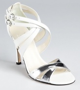 These strappy Stuart Weitzman sandals expertly mix icy white leather and gleaming metallic silver on a dazzling silhouette that gives a breath of fresh air to evening affairs.