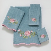 Luxurious velour towel is embellished with a large intricately embroidered rose in tones of pink and green. Finished with a scalloped edge trimmed in pink satin binding.