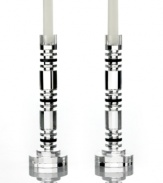 Columns of faceted crystal refract the light of the candle and that of the room, giving Aurora candlesticks their spectacular shine. Alternating small and large disks create a contemporary stacked design ideal for elegant decor. From Lighting by Design.