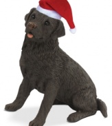 A fetching gift for animal lovers, the chocolate lab Christmas ornament depicts a cuddly pup waiting patiently for treats and dressed for the season. From Sandicast.