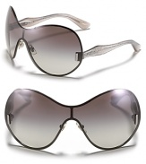 Miu Miu's shield sunglasses with a sleek and curvy silhouette and glittery arms are sure to turn heads.