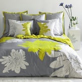 A graphic print in a high fashion palette, the Ashley Citron duvet set is a delightful twist on a Blilssliving Home favorite. Defying standard repeat patterns, our signature chrysanthemums are engineered in stunning scale. Crisp pure white and bright citron green bloom against a base of pewter grey. Matching pillow shams feature a unique double flange. Set reverses to solid grey color way.