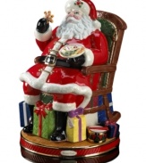 Santa at his merriest. In a classic depiction of St. Nick, Christopher Radko's heirloom Christmas figurine is rich with detail, from colorfully wrapped presents to a plate of fresh cookies.