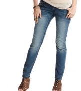 Extreme whiskering and bold topstitching enhance these medium wash skinny jeans with eye-catching style! From Dollhouse.