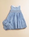 An essential warm-weather dress in crisp cotton poplin is the epitome of adorably polished style with a Peter Pan collar, smocked yoke and pretty bow tie.Peter Pan collarSleevelessBack embossed pearlized buttonsSmocked front yoke with embroidered rosette detailsSelf-tie sash waistbandSweeping flared skirtFully lined slip with tiered rufflesMatching bloomersCottonMachine washImported