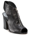 An edgy zipper extends down the front of these sleek leather booties from Stuart Weitzman, exuding downtown cool and modern city chic.