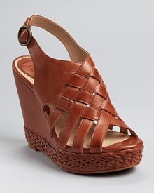 Woven and braided details lend unique appeal to a strappy wedge sandal from Frye. Woven and braided details lend unique appeal to a strappy wedge sandal from Frye.