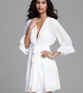 Exude elegance in a three-quarter sleeve wrap with ruffle trim.