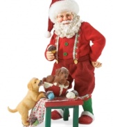 Sweet tooth Santa! Dressed in his pajamas, hat and coordinating slippers, Santa is accompanied by his two furry friends as he enjoys a tasty cupcake.