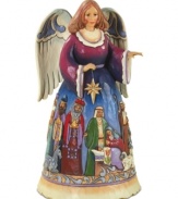 A colorific nativity scene paints itself across this folk-inspired angel's dress and adds to the hopeful & peaceful aura of this accent piece.
