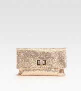 A cocktail essential covered in glittery fabric with a turnlock clasp and rich suede lining.Turnlock flap closureOne inside open pocketSuede lining9W X 6½H X 1/2DImported