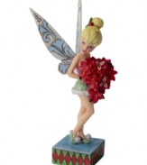 Clap your hands! Holding a bright batch of poinsettias, Tinkerbell makes an unforgettable Christmas debut. This precious fairy flutters airy wings that are emblazoned with a delicate, floral-inspired design.