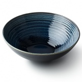 Subtle gradations of blue and beige make each piece of this glazed dinnerware unique and alluring.