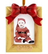 Never forget it! Wrapped in a red bow, this goldtone picture frame ornaments your tree with a special holiday memory. Dated 2012.
