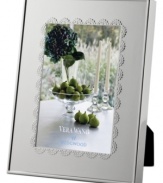 A delicate lace-inspired pattern trims sleek silver plate, giving Vera Wang's Flirt picture frame a sense of timeless grace and femininity.