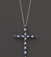 Diamonds and sapphires in a 14K white gold cross pendant on a fine chain.