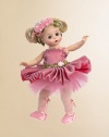 This fully-articulated Wendy doll has blue eyes and side-parted ivory hair styled into looped pigtails and decorated with a pink butterfly headband that is embellished with pink ribbon and white pearls. Her tutu of pink metallic organza over salmon colored charmeuse features a pleated skirt and pink tulle underskirt. The bodice of Butterfly Ballerina's dress is accented by a pink, green, and tan flower trim at the neckline and two trims at the waist.