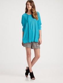 This luxuriously oversized knit drapes in a featherweight pullover styled with a soft front ruffle.BoatneckDropped shouldersLong sleevesAbout 27 from shoulder to hem52% cotton/48% rayonDry cleanImportedModel shown is 5'10 (177cm) wearing US size XS/S.