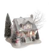 A friendly snowman stands watch over the picture-perfect Cottagewood Bungalow, one of the most charming in the Village. Although snow continues to fall outside, it's warm inside and smells of Christmas cookies baking in the oven. From Department 56.