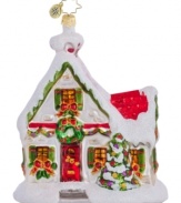 A model home, this beautifully decked ornament boasts brilliant colors and a fresh dusting of snow, all in mouth-blown, hand-painted glass from Christopher Radko.