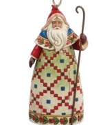 Inspired by traditional tales of St. Nicholas, Jim Shore's Santa figurine wears a beautiful, hand-painted Scandinavian robe and carries a slender staff to symbolize his good-hearted nature. Display standing or hang as an ornament.