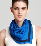 A lightweight scarf with a large yet subtle polka dot Tory Burch logo print