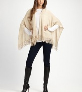 A casual style with an open drape front, warm hood and pretty fringe details in luxurious cashmere. HoodedOpen, draped frontPull-over styleFringed hemAbout 28 from back shoulder to hemCashmereDry cleanImported 