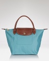 A timeless and durable nod to French style, Longchamp's nylon tote perfects daily errand-running for the très chic girl about town.