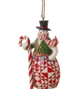 Carrying a candy cane staff to match his scarf, this crafty snowman plays it cool with elaborate carved and quilt-patterned detail in the signature folk-art style of Jim Shore.
