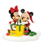 Taking style cues from Santa Claus, Mickey and Minnie sport holiday red as they put the finishing touches on a perfectly wrapped present. A great gift itself, this collectible figurine is cute for kids' rooms.