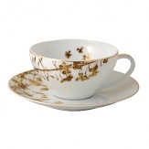An delicate leaf pattern decorates this fine tea saucer that's rimmed with gold for dazzling opulence, versatile enough to complement Bernardaud's Diamond and Palmyre collections.