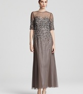 Sprinkled with sparkling sequins, this Adrianna Papell gown boasts a sheer yoke and floor-sweeping chiffon skirt.